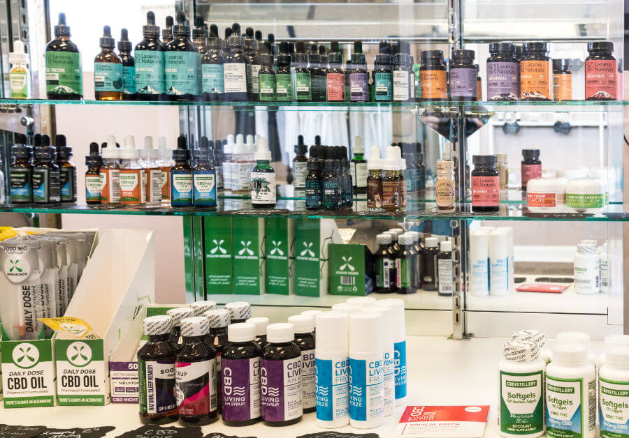 Multiple CBD products in a display case with white background.